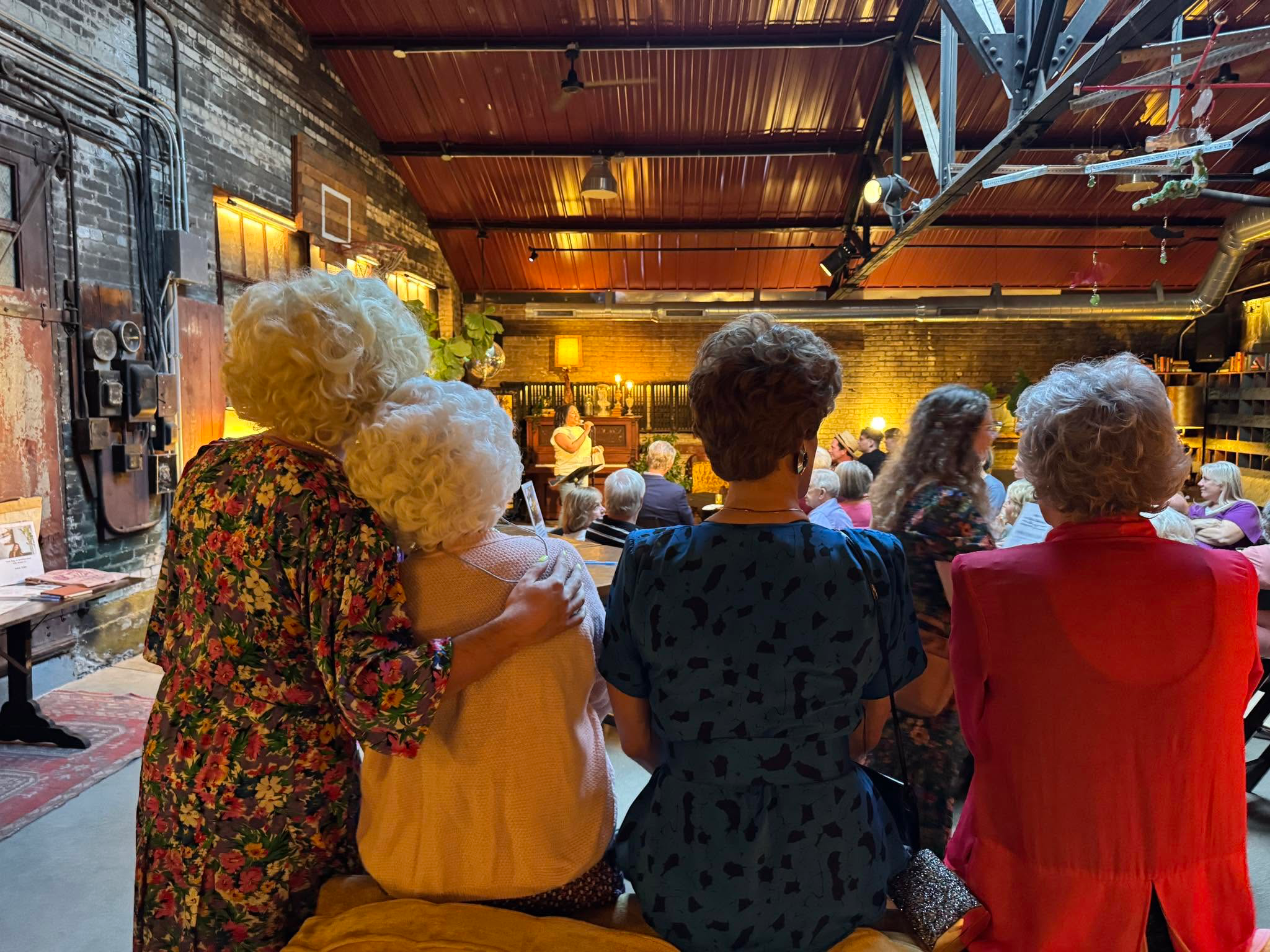 The Golden Girls cast seen from behind, together and facing the stage.